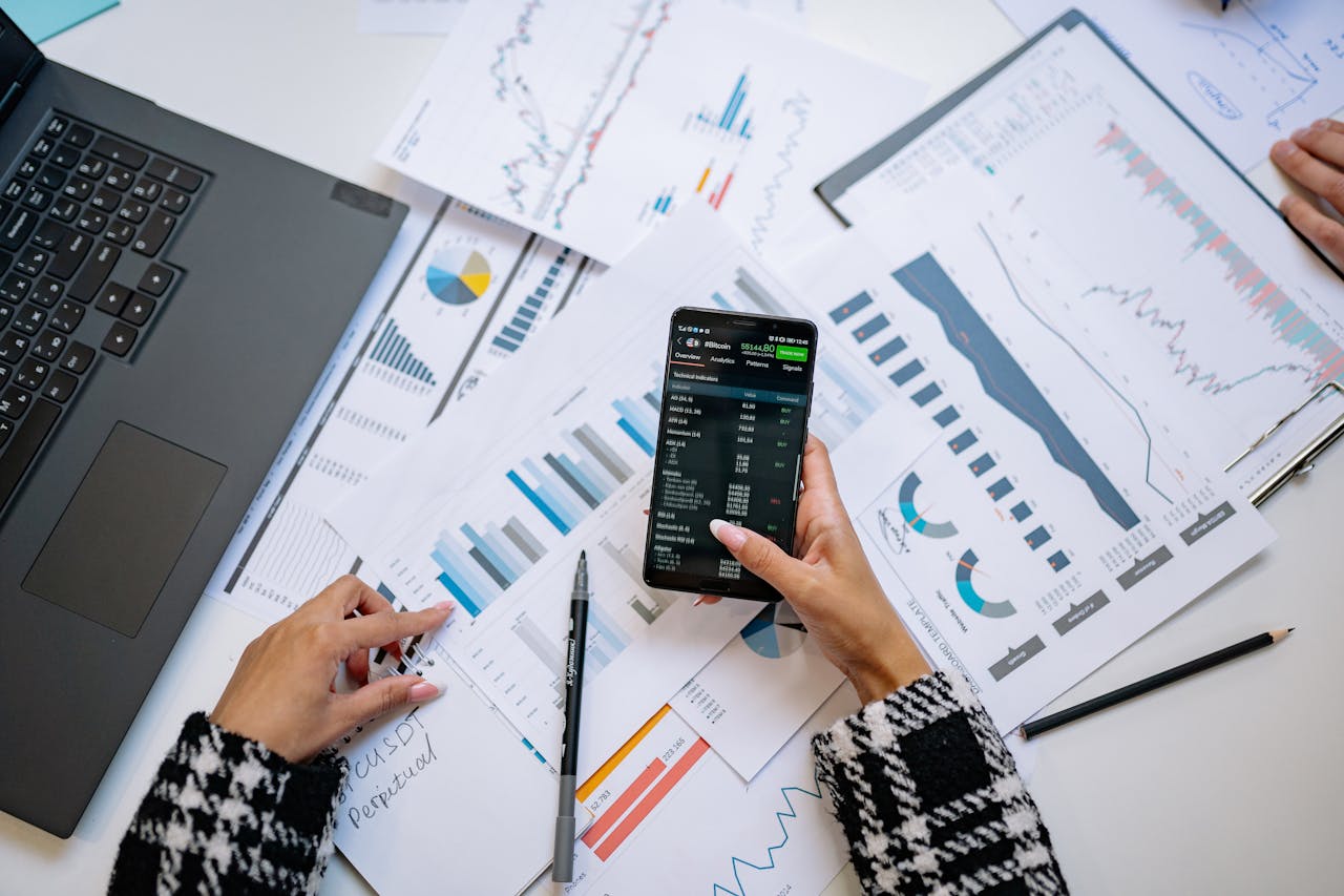 A top view on charts and smartphone in an office, showcasing data analytics.